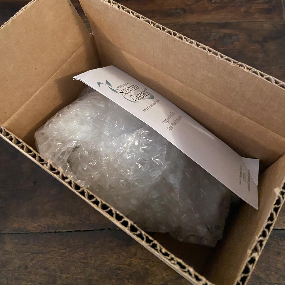 Open Cardboard Box With a Discount Neti Pot Bubble Wrapped