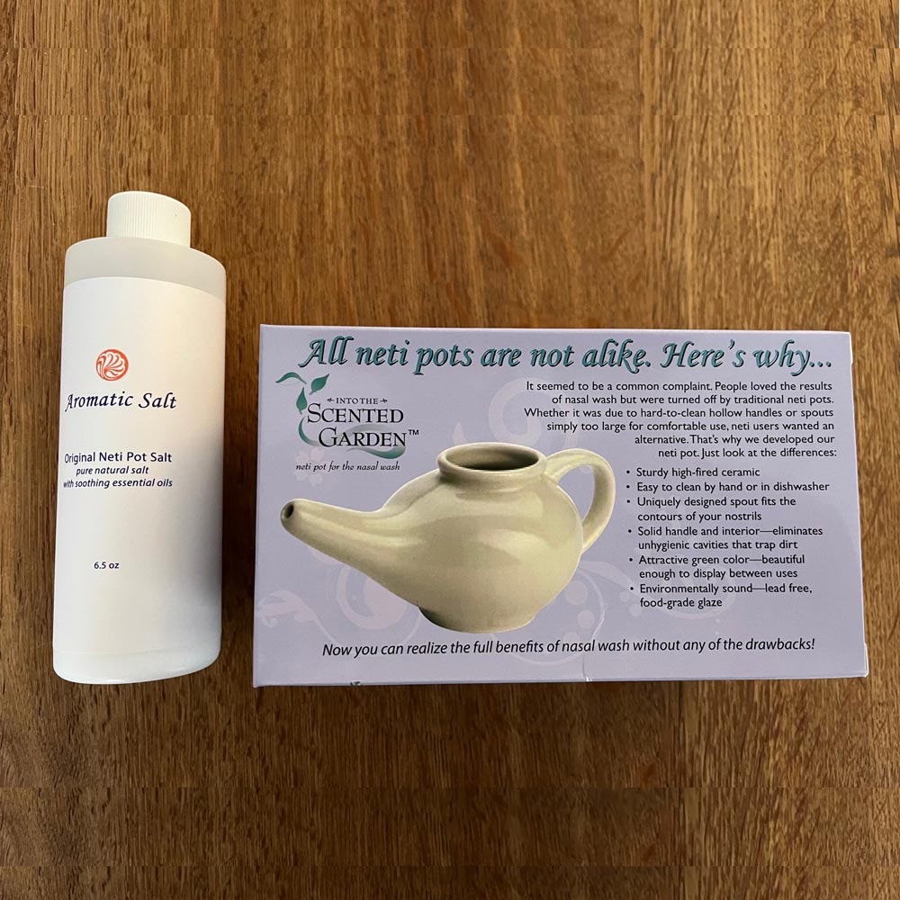 Scented Nasal Rinsing Kit Neti Pot and Scented Aromatic Solution Salt On a Wood Dining Table